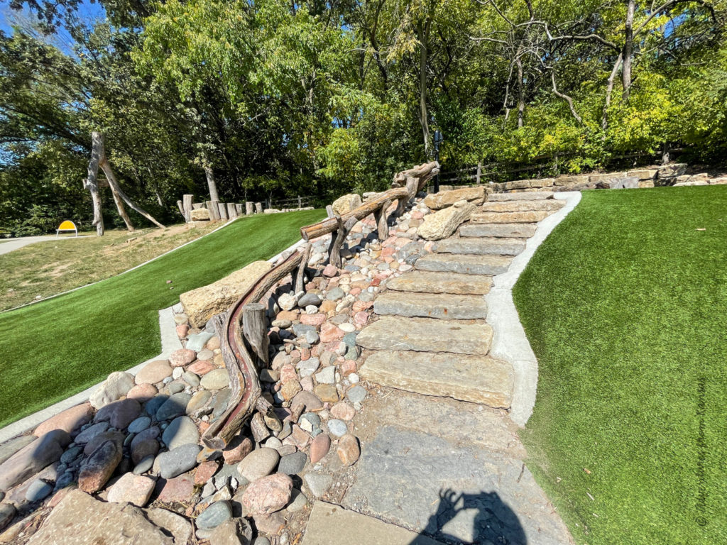 nature play area with rocks and logs