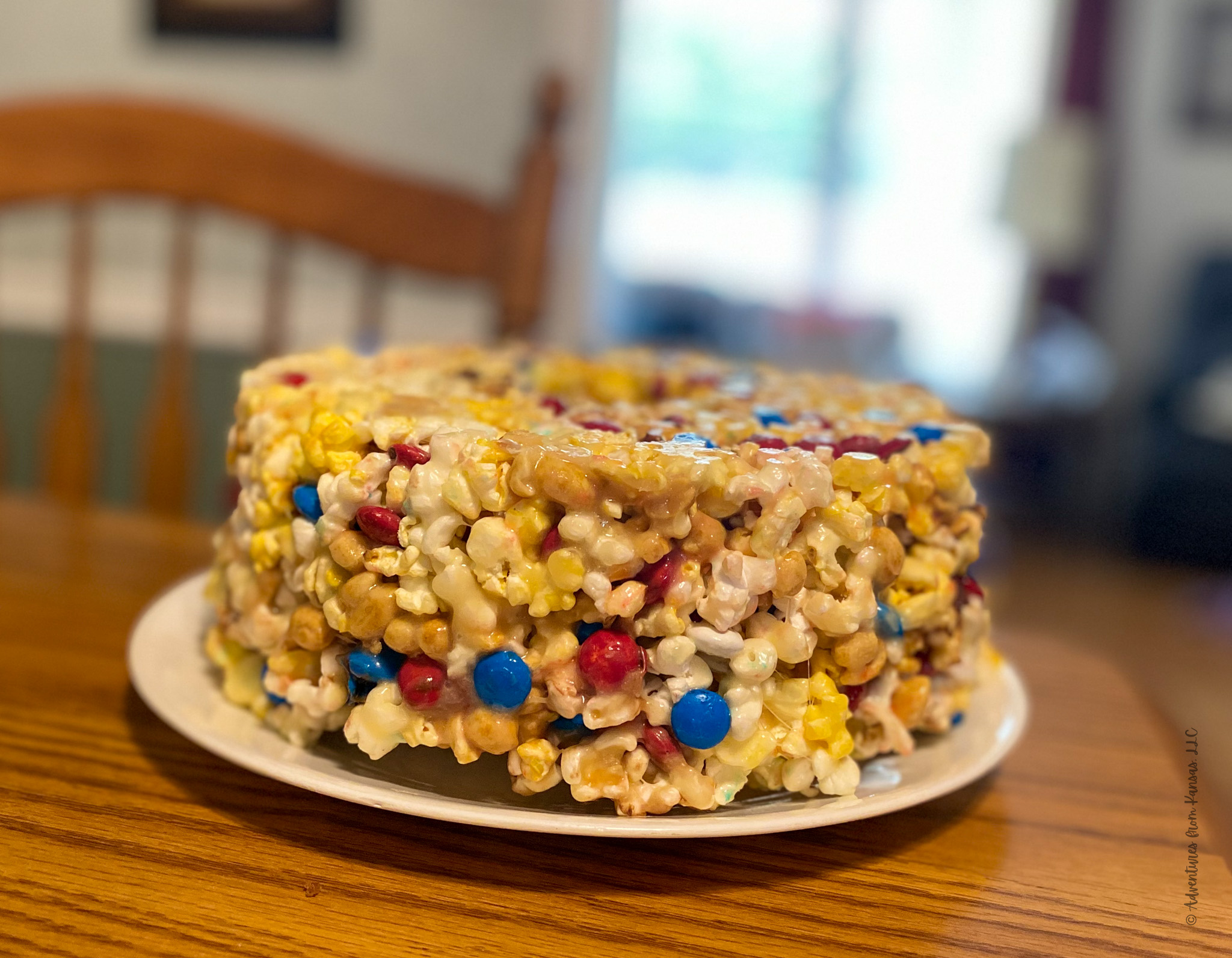 popcorn cake sitting on table with chair in background