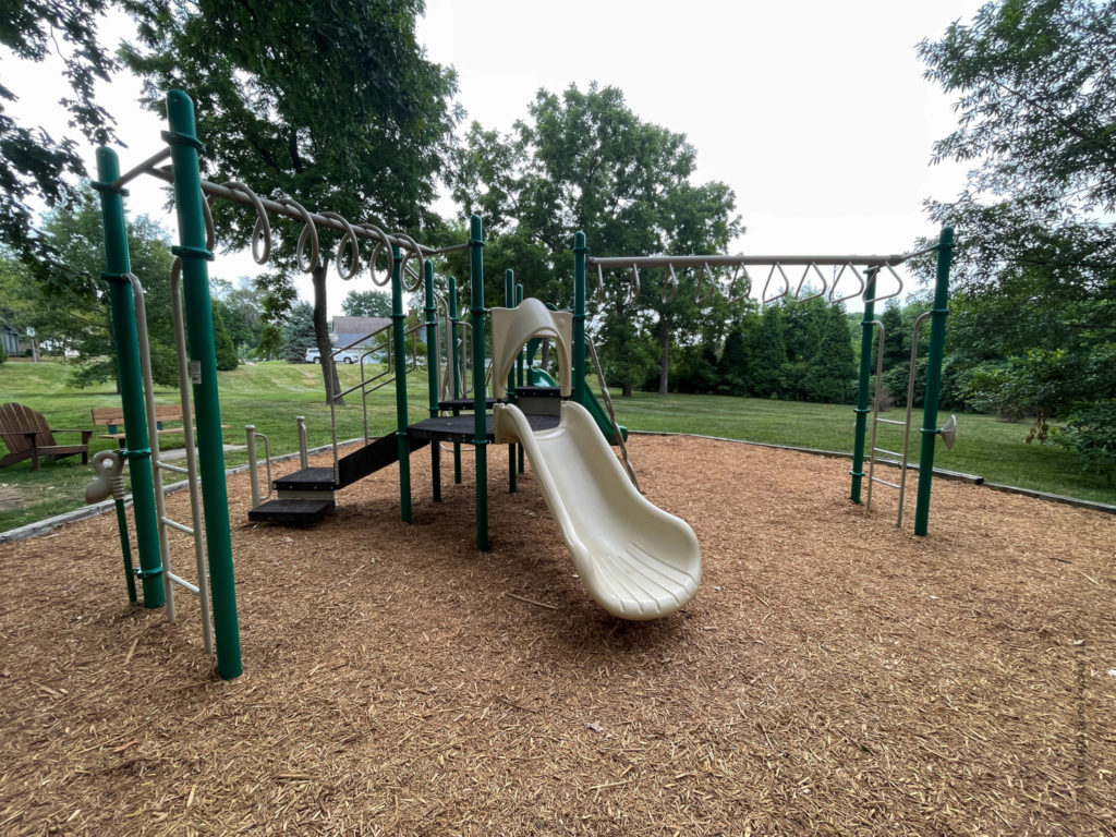 Cream slide and monkey bars on playground