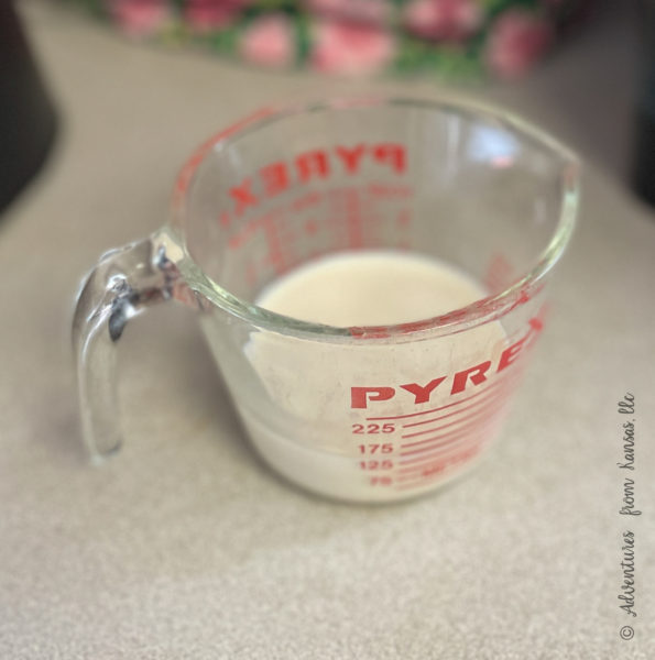 vinegar and milk in measuring cup to make buttermilk on counter