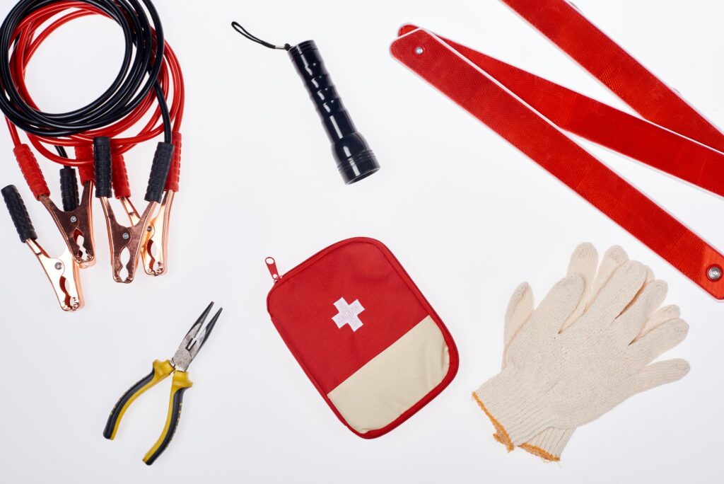 jumper cables, gloves, pipers, flashlight of an emergency kit