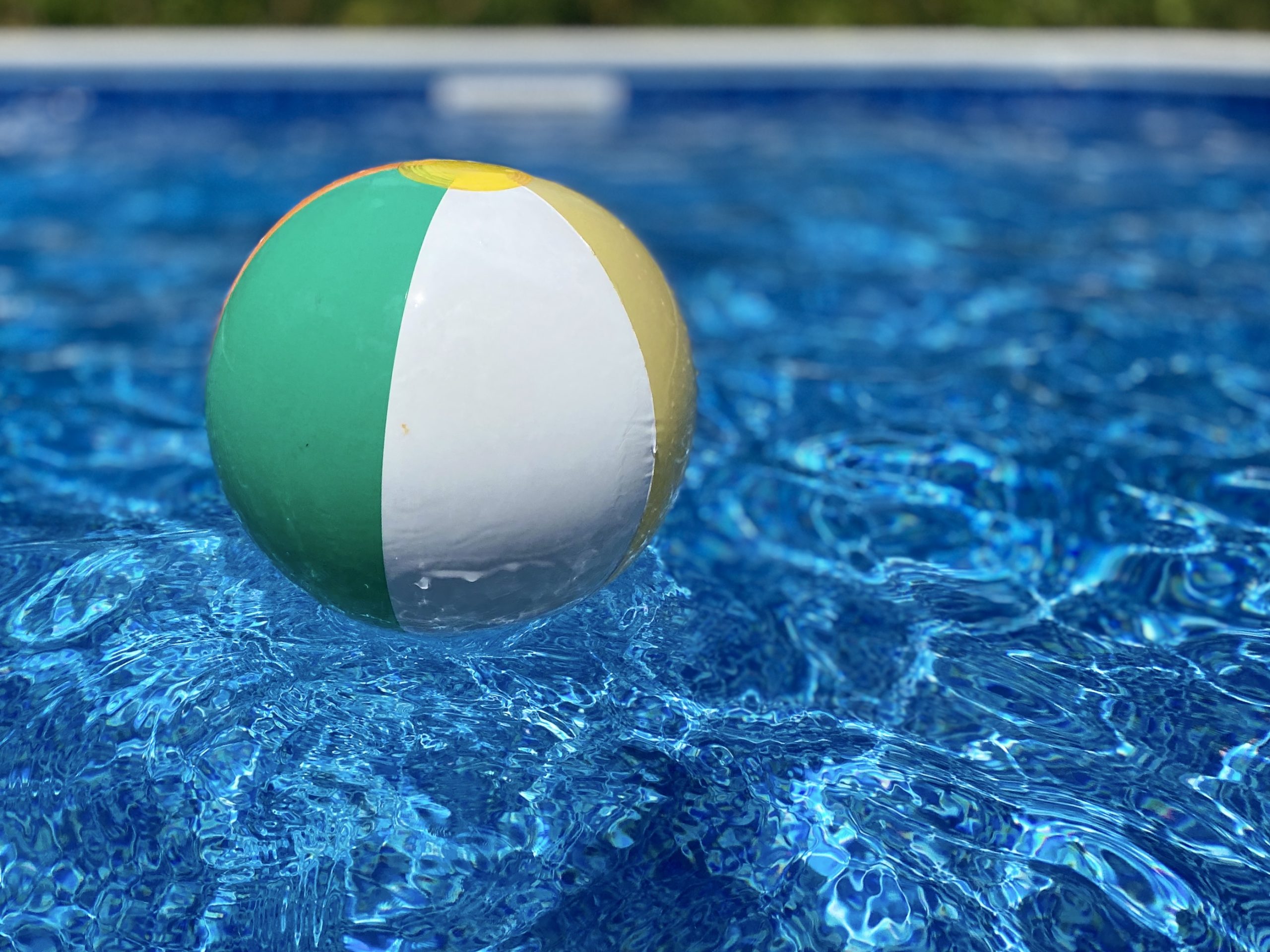 Beach ball floating in a pool