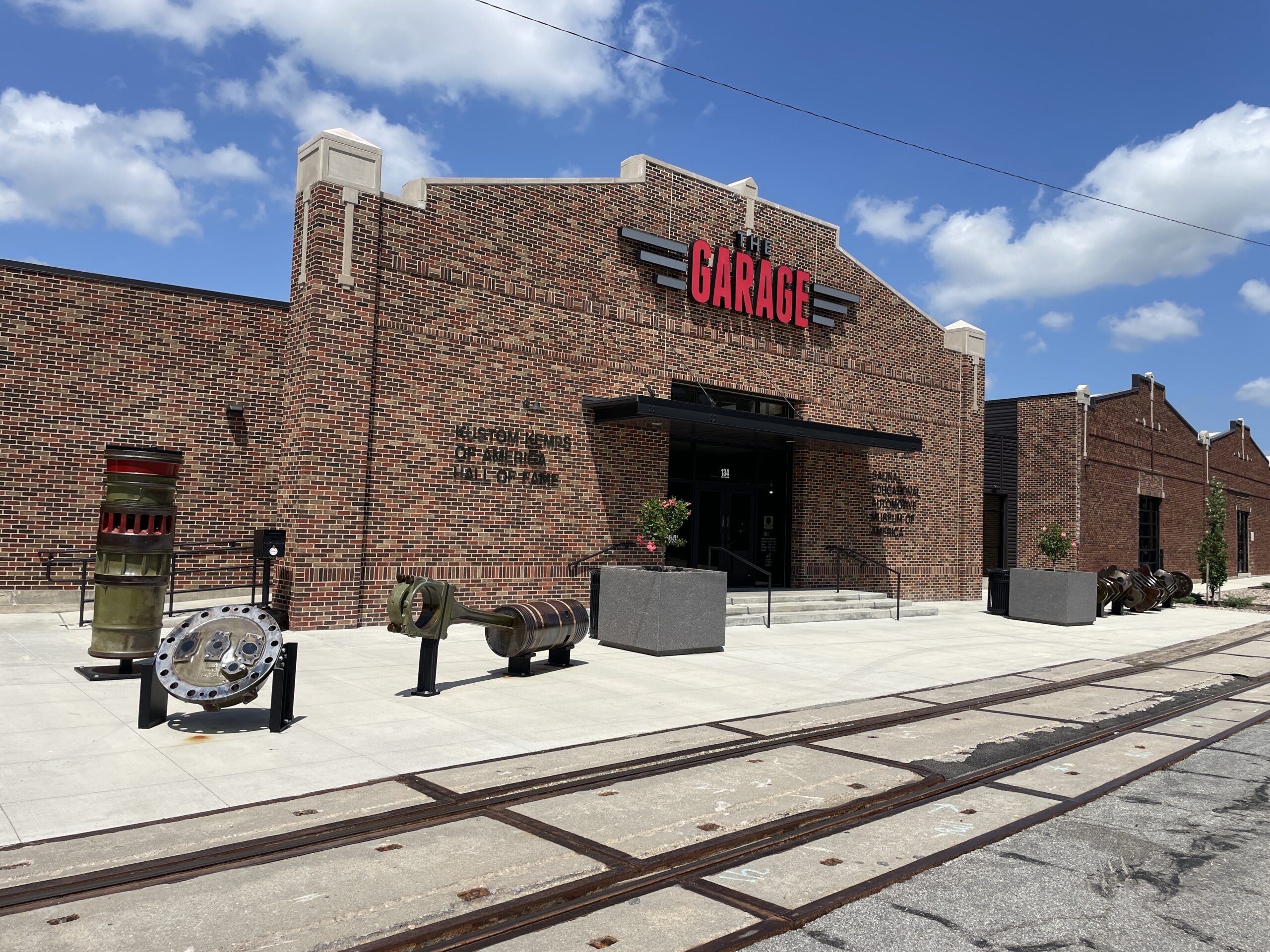 picture of the outside of a brick building in Salina, KS with train track out from housing the garage