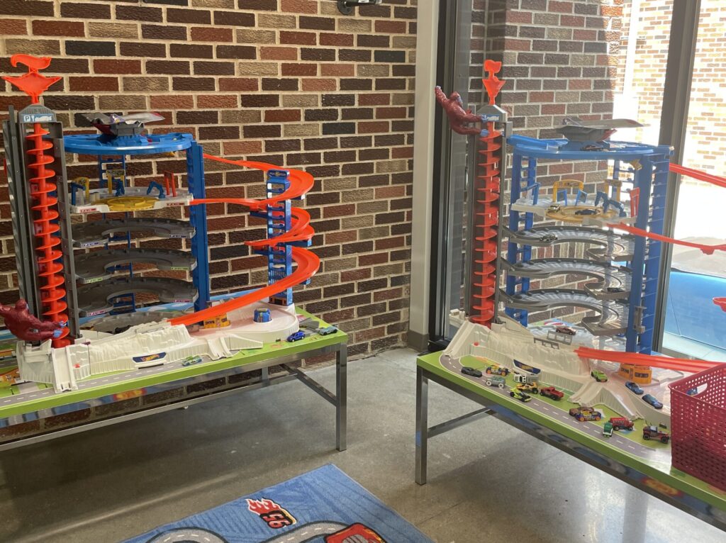 Hot Wheel garages on top of tables with car run inside the garage in Salina 