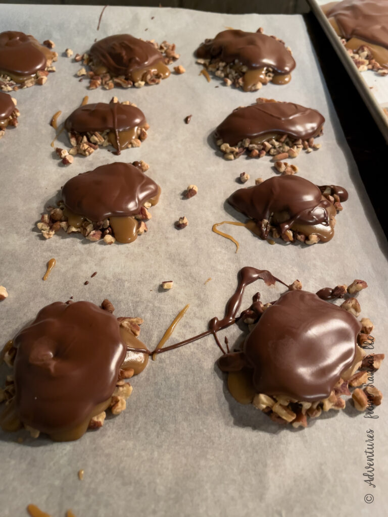 nuts Carmels and chocolate on a cookie sheets turtles
