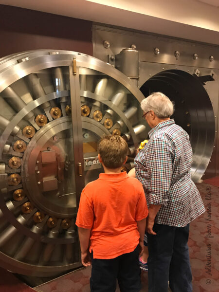 grandma and kids looking at the old bank vault in the old downtown library
